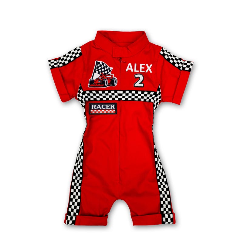 Close-up focusing on the front details of the racing romper. Features a central zipper, collar detail, and various racing logos on the chest. Checkered side stripes add a sporty look, while the soft fabric ensures full comfort for active babies and walking toddlers.