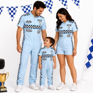 May include: Light blue racing-themed jumpsuits and a romper featuring black and white chequered stripes, crossed flag graphics, and the numbers 2 and 95. The garments include text labels DAD, MOM, and Levi, with short sleeves and front zippers.