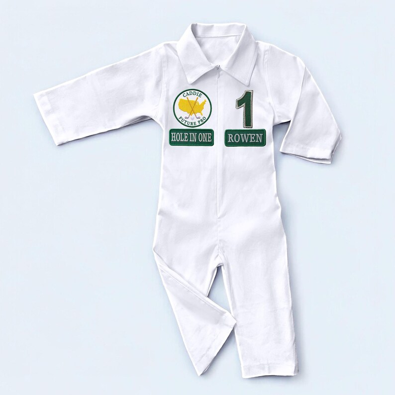 A professional flat lay of the long-sleeved white golf caddy costume. The garment is spread out to show the elastic waistband, the structured collar, and the symmetrical placement of the green patches. This clean layout allows shoppers to visualize the overall silhouette and design of the uniform at a single glance.