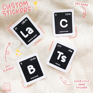 May include: Custom stickers with a black and white design, resembling periodic table elements. Each sticker features a letter, a name, and numbers. The stickers are labeled "Custom Stickers" and "Cutie Little Name Stickers".