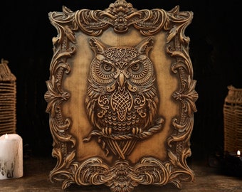 May include: A wooden wall decor featuring a carved owl with intricate details. The owl is surrounded by a decorative frame with ornate carvings.