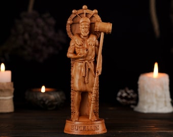 May include: A wooden statue of a bearded man holding a hammer and a cup. The statue is standing on a wooden base with the word "SUCHARIUS" inscribed on it. The statue is surrounded by candles and other decorative items.
