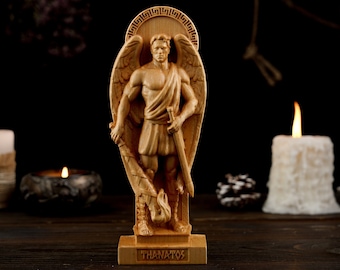 May include: A wooden statue of Thanatos, the Greek god of death, depicted as a winged angel holding a sword and a torch. The statue is standing on a wooden base with the word "Thanatos" inscribed on it.
