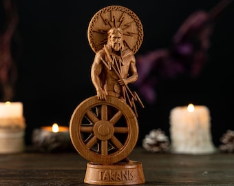 May include: A wooden statue of Taranis, a Celtic god, holding a wheel and lightning bolts. The statue is carved from light brown wood and stands on a base with the name "TARANIS" carved into it. The background is dark, with lit candles and pine cones.