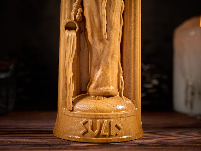 May include: A wooden statue of a woman holding a pitcher, with the word "SUVIS" carved into the base.