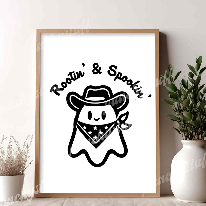 a wood frame with a black and white print of a cowboy ghost that says "Rootin' and Spookin'"