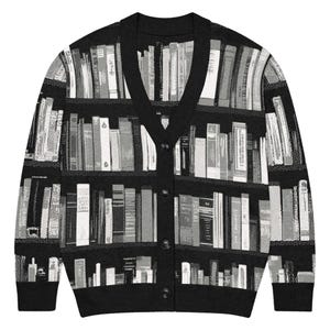 May include: Black cardigan sweater with a V-neck and button closure. The sweater features a unique print of a bookshelf filled with books in shades of gray and white. The design covers the entire sweater.