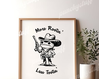 May include: Black and white illustration of a frog wearing a cowboy hat and holding a gun. The text "More Rootin', Less Tootin'" is below the frog.
