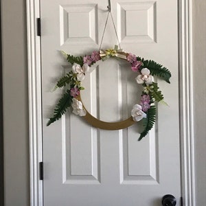 Spring wreath with roses and yellow and pink flowers