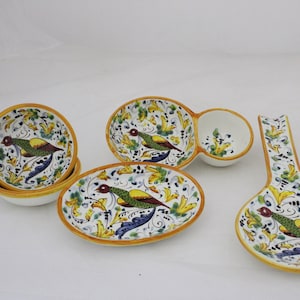 Puede incluir: Conjunto de cinco platos de servir de cerámica con fondo blanco y un diseño floral y de pájaros colorido. Los platos incluyen un tazón pequeño, un tazón más grande con una sección para salsa, una bandeja ovalada y dos cucharas para servir.