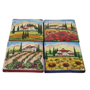 May include: A set of four square ceramic coasters, each with a different Italian countryside scene. The designs include a villa, red poppies, a vineyard, and sunflowers. The coasters are hand-painted with vibrant colours, evoking a rustic charm.