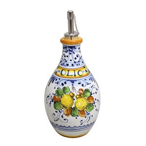 May include: White ceramic olive oil bottle with a decorative design. The bottle features a floral pattern with yellow lemons and green leaves. The word "OLIO" is written in yellow. It has a metal spout with a chain and a yellow and orange neck.