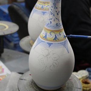 Our master painter is decorating the oil bottle