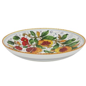 May include: Oval ceramic serving dish with a hand-painted floral design. The dish features red flowers, yellow and orange pomegranates, and green leaves against a white background. The rim has a yellow and blue border, adding a decorative touch.