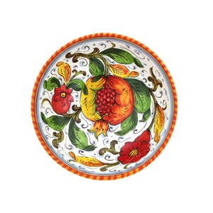 K&ouml;nnte beinhalten: Eine runde, handbemalte Keramikschale mit wei&szlig;em Innenraum und dekorativem Rand. Die Schale zeigt ein lebendiges Design einer Granatapfel, Blumen und Bl&auml;tter in Rot-, Gelb- und Gr&uuml;nt&ouml;nen. Der Rand hat ein rot-gelbes Seilmuster.