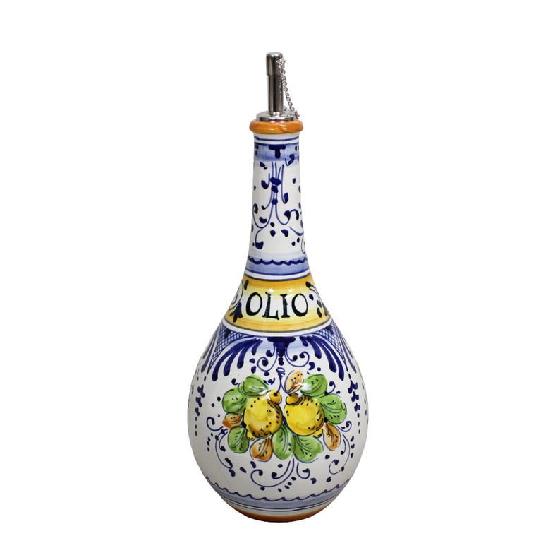 May include: A ceramic olive oil bottle with a decorative design. The bottle is white with blue and yellow accents, and features a floral and fruit motif. The word "OLIO" is printed on the bottle. It has a metal spout with a chain.