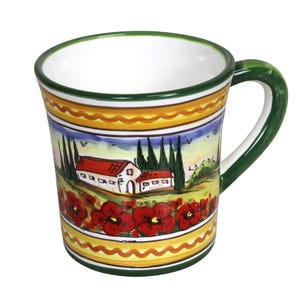 May include: Ceramic mug with a hand-painted Italian countryside design. The mug features a white interior, a green handle and rim, and a colorful exterior with red poppies, houses, and trees. The mug is approximately 4 inches tall.
