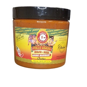 May include: A 16-ounce jar of Kuko's Pollo Asado Rojo-Red Adobo Marinade for Chicken. The jar is orange and yellow with a black lid. The label features a red and green illustration of a chicken and the text "Kuko's Mexican Food".