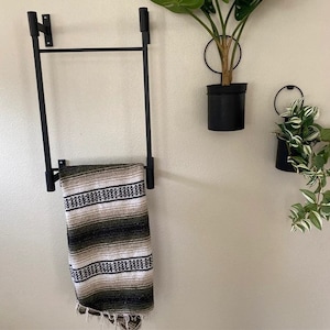 small wall mounted decorative ladder for hanging blankets