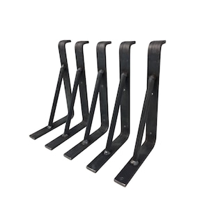 May include: Five black metal shelf brackets, each with a triangular shape and a flat base. The brackets are arranged in a row, with the bases facing the viewer.