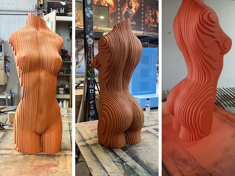 May include: A three-dimensional sculpture of a human torso made of layered wood. The sculpture is painted a bright orange color. The sculpture is shown in three different stages of completion.