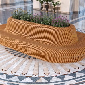 May include: A long, curved wooden bench with a planter built into the top. The bench is made of light brown wood and has a wavy, organic shape. The planter is filled with green plants and purple flowers.