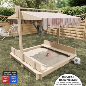 May include: A wooden sandbox with a striped canopy, perfect for outdoor play. The sandbox has a built-in bench and is surrounded by a green lawn.