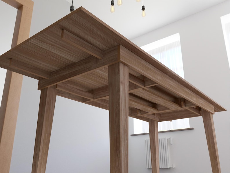 May include: A wooden dining table with a rectangular top and four legs. The table is made of light brown wood and has a simple, modern design.