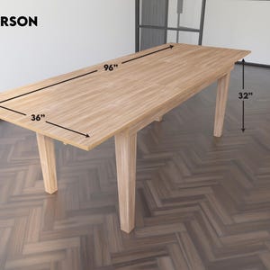 May include: A light wood dining table with a 96-inch length and 36-inch width. The table has four legs and is 32 inches tall. The table is labeled "8 PERSON".