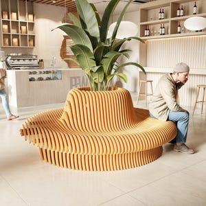 May include: A large, wooden, curved bench with a unique design. The bench is made of light brown wood and has a series of curved slats that create a wave-like effect. The bench is in a modern cafe setting with a plant in the center.