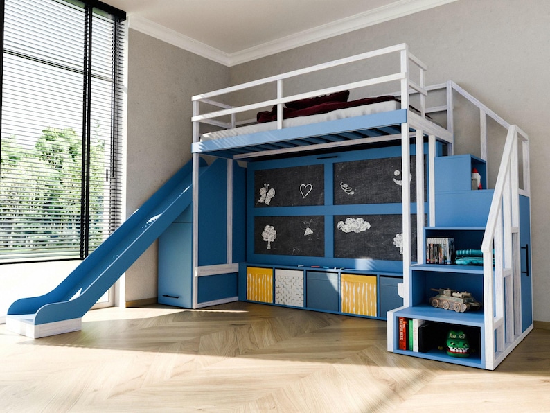 May include: A blue and white bunk bed with a slide and stairs. The bed has a chalkboard wall with drawings, storage cubes, and shelves with toys. The slide is on the left, and the stairs are on the right.
