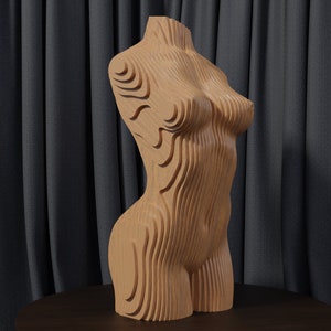 May include: A wooden sculpture of a human torso with a layered, geometric design. The sculpture is made of light brown wood and has a smooth, polished finish.