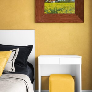 May include: A white bedroom set with a bed, nightstand, and stool. The bed has a white headboard and a white comforter. The nightstand is white with two drawers. The stool is yellow and has a square shape.