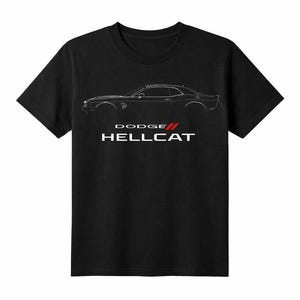 May include: Black t-shirt featuring a white outline of a Dodge Hellcat car. Below the car outline are the words "DODGE" and "HELLCAT" in white, with a red stripe between them. The shirt is made of a soft material.