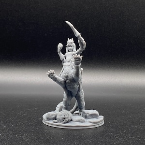 May include: A gray 3D printed miniature of a female figure riding a lion. The figure is wearing a crown and holding a sword. The lion is standing on a circular base.
