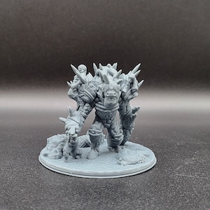 May include: A gray, detailed miniature of a creature with a spiky, armored body and a horned head. The creature is standing on a round base.