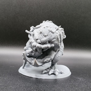 May include: A gray, 3D-printed fantasy creature figurine. The monster has a large head with sharp teeth, textured skin, and a menacing expression. It stands on a circular base, with detailed claws and a hunched posture, suggesting a dynamic pose. The overall design is intricate.