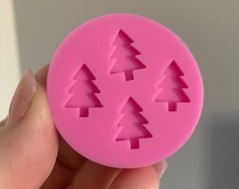 May include: Pink silicone mould with four Christmas tree shapes.