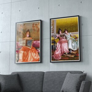 May include: Two framed paintings of women wearing face masks and sitting on a couch. The women are dressed in long, flowing gowns. The paintings are set against a neutral background.