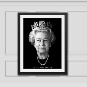 Puede incluir: Un retrato enmarcado en blanco y negro de la reina Isabel II con una corona y un collar de perlas. El texto ONE IS NOT AMUSED está impreso en blanco en la parte inferior de la imagen. El retrato está sobre un fondo negro sólido.