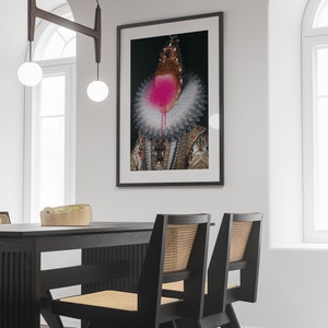 May include: A black framed print of a portrait of a person wearing a large white ruff collar and a crown. The person's face is obscured by a pink spray paint splatter.