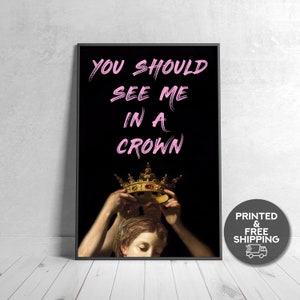 May include: A black and white print of a painting of a person wearing a gold crown. The text "YOU SHOULD SEE ME IN A CROWN" is written in pink on a black background.