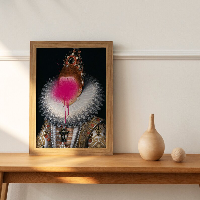 May include: A framed portrait of a person wearing a white lace collar and a gold and red patterned dress. The person's face is obscured by a pink spray paint splatter.