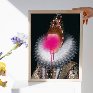 May include: A framed portrait of a person wearing a white lace collar and a jeweled crown. The person's face is obscured by a pink spray paint splatter.