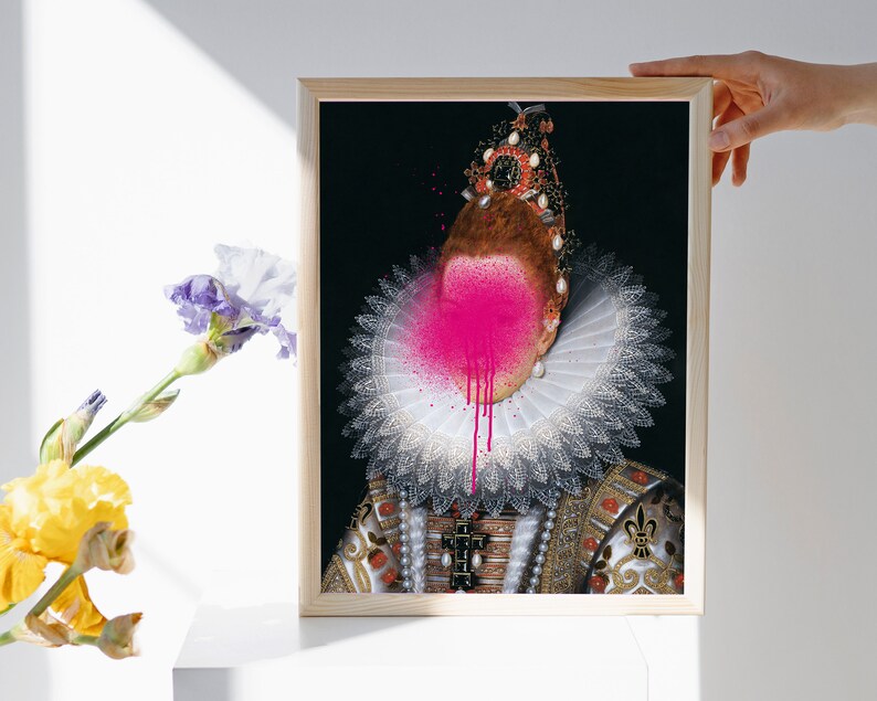 May include: A framed portrait of a person wearing a white lace collar and a jeweled crown. The person's face is obscured by a pink spray paint splatter.