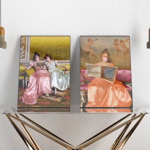 May include: Two framed prints of women in vintage dresses. The woman in the left print is reading a book with another woman. The woman in the right print is reading a newspaper and has a bubble of pink gum in her mouth.