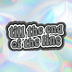 May include: A gray and white sticker with the text "till the end of the line" in a retro font. The sticker has a star in the corner.