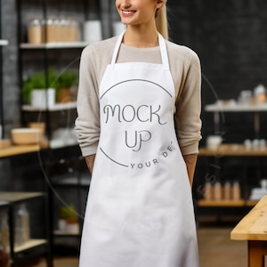 May include: White apron with adjustable straps and a large circle on the front that says "MOCK UP YOUR DESIGN".