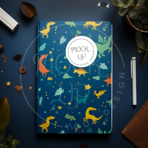 May include: A blue notebook with a colorful dinosaur pattern and a white circle with the text "Mock Up Your Design".