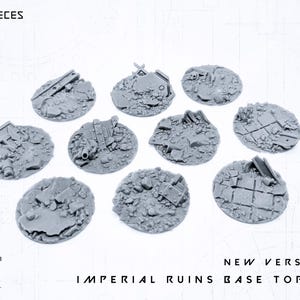 May include: Ten gray Imperial Ruins Base Toppers, each with a unique design of rubble and debris. The toppers are circular and feature architectural details, perfect for miniature wargaming. The text "10X PIECES" and "NEW VERSION! IMPERIAL RUINS BASE TOPPER" are visible.